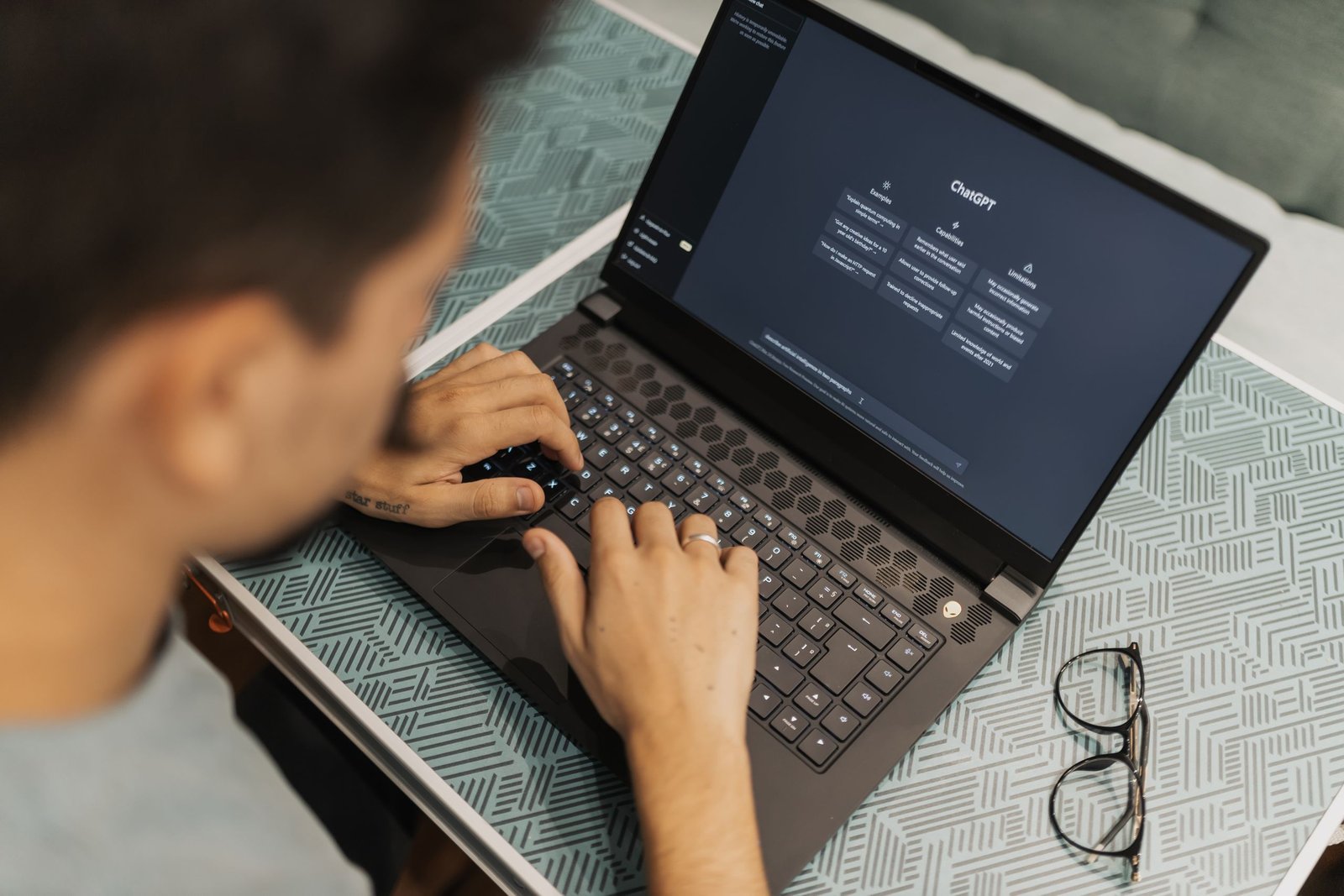 A man working on a laptop with AI software on the screen
